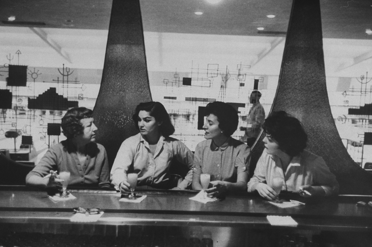 Women at bar in bowling alley celebratin
