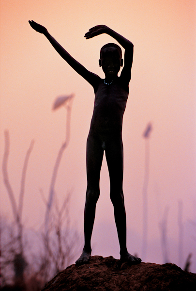 Dinka Child Imitating Horns of Favourite Bull