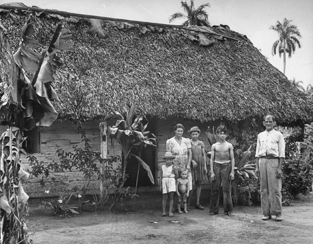 A cane cutter and his family standing in